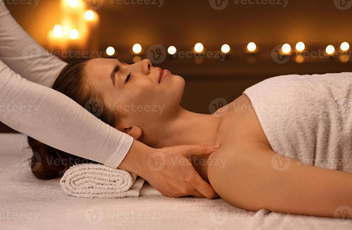 imgi_472_peaceful-young-woman-having-relaxing-full-body-massage-at-newest-luxury-spa-decorated-with-candles-female-therapist-rubbing-sleeping-lady-shoulders-giving-relaxing-and.jpg